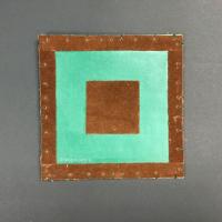 This piece is comprised of a foldable, square piece of stiff green paper that has a brown velvet square in the middle, as well as brown velvet trim. Once unfolded, the interior is a green linocut print with a small collage with a turtle on the middle square.